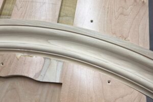 Curved molding created on Williams & Hussey Molder during custom molding production.