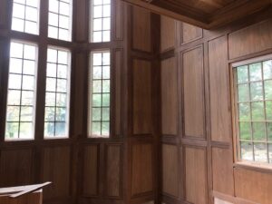 Custom walnut wall paneling produced in-house using a Williams & Hussey molder